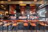 Community bar area with a towering ceiling and wood counters