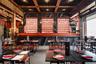 Wine room featuring beam ceiling