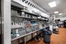 Kitchen featuring a paneled ceiling, tasteful backsplash, stainless steel counters, and tile walls
