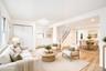 Open-concept interior featuring wood-finish flooring, recessed lighting, double-panel sliding closet doors, and a staircase with white balusters *virt