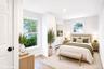 Bright interior room featuring vinyl wood-finish flooring, recessed lighting, and multiple double-hung windows