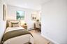 Bright room featuring wood-finish flooring, recessed lighting, and multiple windows *virtually staged