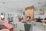 Vaulted ceiling with recessed lighting, stone fireplace, and multiple sets of glass-paned double doors