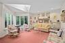 This room doubles as a den and 2nd bedroom. Vaulted ceiling featuring a large skylight, expansive windows, and wall-mounted shelving units