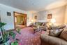 Large living room featuring natural wood molding, hardwood floors.