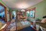 Dining space featuring wood-finish flooring, custom moldings, hardwood floors and an expansive bay window.