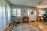 Entrance foyer/sitting area with large windows for plenty of natural light, closets and wood floors.