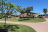 Single-story residence featuring a brick and siding exterior, expansive lawn, mature landscaping, and a concrete driveway