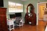 Room featuring wood-finish flooring and a horizontal window with slatted blinds