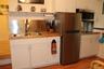 White shaker-style cabinetry, wood-surface countertops, stainless steel appliances, dual-basin stainless steel sink with high-arc faucet, and stainles