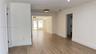 Interior space featuring wood-finish flooring, crisp white walls, flush-mount ceiling lighting, and multi-pane glass doors