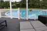 Composite deck featuring a white railing enclosure and a circular above-ground pool