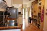 Kitchen featuring a butcher block countertop, stainless steel dual-basin sink with a high-arch faucet, wood-finish flooring, and floor-to-ceiling buil