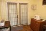 French doors featuring multi-lite glass panels, vertical paneled wall treatments, and wood-finish flooring