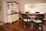 Wood-finish flooring, crystal-style chandelier, and an arched wall opening