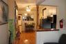 Kitchen featuring white cabinetry, stainless steel appliances, and a wood-finish pass-through counter supported by a decorative wood column, complemen
