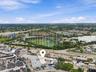 Aerial perspective featuring a commercial warehouse structure with a flat roof system and multi-bay exterior access