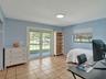 Room featuring tile flooring, glass-paneled double doors, and a built-in recessed shelving unit