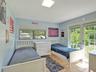 Room featuring ceramic tile flooring, a dual-pane horizontal sliding window with roller shade, and glass-paned double doors providing access to the ex