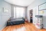 Wood-finish flooring, neutral wall tones, large window with natural light, and closet with louvered bi-fold doors