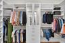 Dual Walk In Closets with Custom Cabinetry and Shelving.