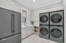 Dual double stack Washer and Dryer.  Color matched refrigerator.