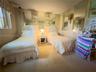 Room featuring wall-to-wall carpeting, floor-to-ceiling wall mirror panels, and patterned wainscoting