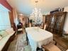 Dining area featuring a built-in window seat, ornate crystal chandelier with ceiling medallion, and custom built-in wooden cabinetry