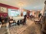 Flagstone flooring, large bay window with built-in bench seating, decorative ceiling medallion, and ornate wood-spindle banister
