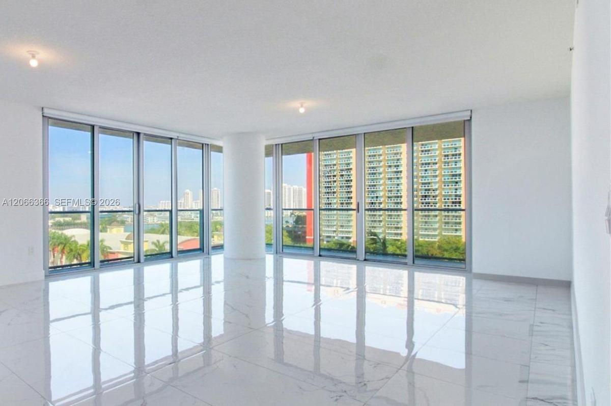 Floor-to-ceiling windows, polished stone-finish flooring, structural column, and recessed ceiling lighting