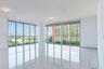 Floor-to-ceiling windows, polished stone-finish flooring, structural column, and recessed ceiling lighting