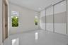 Polished tile flooring, floor-to-ceiling sliding glass-panel closet doors, and dual casement windows with integrated shades