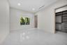 Neutral-toned interior featuring large-format tile flooring, recessed lighting, and a walk-in closet equipped with custom built-in shelving and drawer
