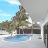 Backyard area featuring a kidney-shaped pool, grey paver decking, white metal fencing, and mature palm trees