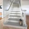 Staircase featuring white balusters, painted treads, and a curved handrail