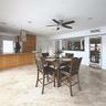Natural stone flooring, custom wood cabinetry, stainless steel range hood, and built-in wine refrigeration