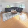 Spacious interior featuring wood-finish flooring, recessed lighting, and multiple large windows