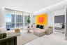 Floor-to-ceiling windows, polished stone-finish tile flooring, and recessed ceiling lighting