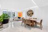 Large-format tile flooring, vertical wall paneling, recessed lighting, and floor-to-ceiling glass windows