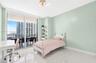 Floor-to-ceiling sliding glass doors, polished stone-finish flooring, and built-in shelving