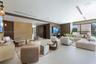 Large living area featuring large-format tile flooring, recessed ceiling lighting, linear HVAC diffusers, and sliding glass wall panels