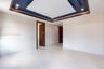 Tray ceiling featuring recessed lighting and dark-toned trim, large-format tile flooring, and solid wood-finish interior doors