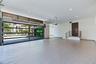 Multi-car garage featuring a full-glass overhead door, speckled epoxy flooring, recessed lighting, and a raised entry platform with a metal railing