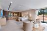 Built-in wood-finish cabinetry, recessed ceiling lighting, large-format tile flooring, and floor-to-ceiling glass sliding doors