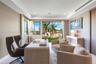 Room featuring textured wallpaper, recessed lighting, crown molding, built-in recessed wall shelving, and floor-to-ceiling glass doors with outdoor sc
