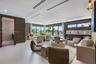 Large-format tile flooring, recessed linear lighting, floor-to-ceiling glass sliding doors, built-in wet bar with stone backsplash, and dark textured 
