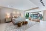 Large format tile flooring, recessed ceiling lighting, and floor-to-ceiling sliding glass doors featuring exterior waterfront scenery