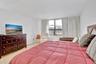 Spacious room featuring large windows, neutral wall finishes, and polished hard-surface flooring