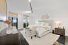 Spacious room featuring polished stone flooring, floor-to-ceiling windows, roller shades, and adjustable track lighting