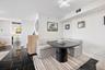 Polished dark stone-finish flooring with white veining and modern geometric overhead lighting